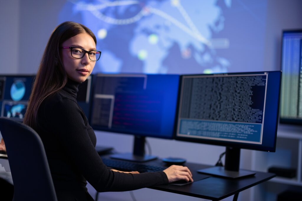 Female IT Consultant in cyber security team working to prevent security threats, find vulnerability