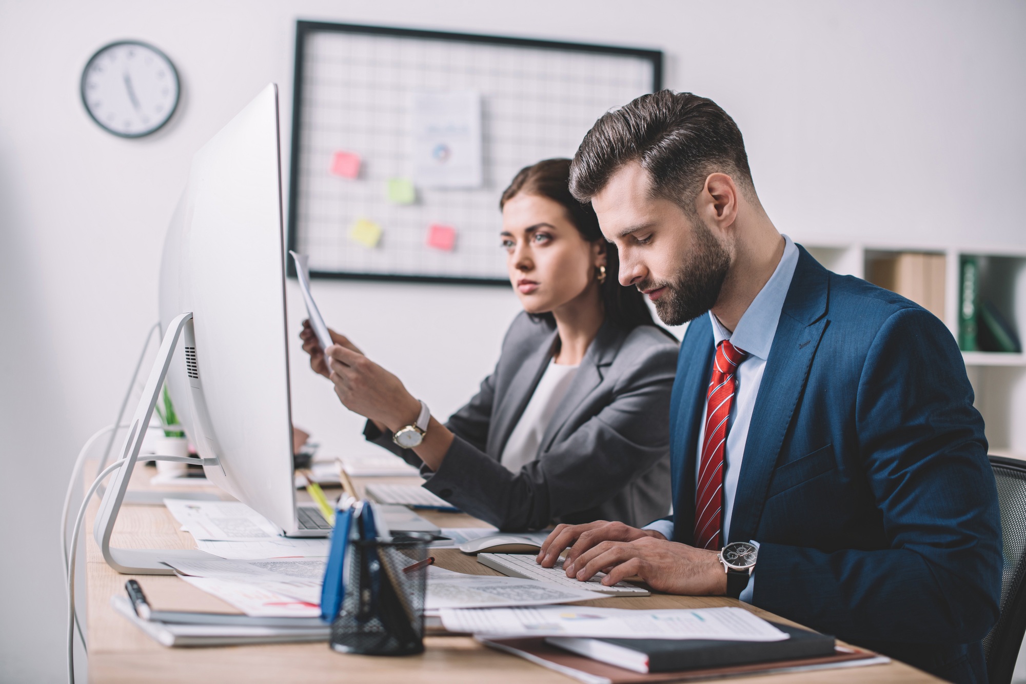 Selective focus of information security analysts assessing vulnerability at table in office
